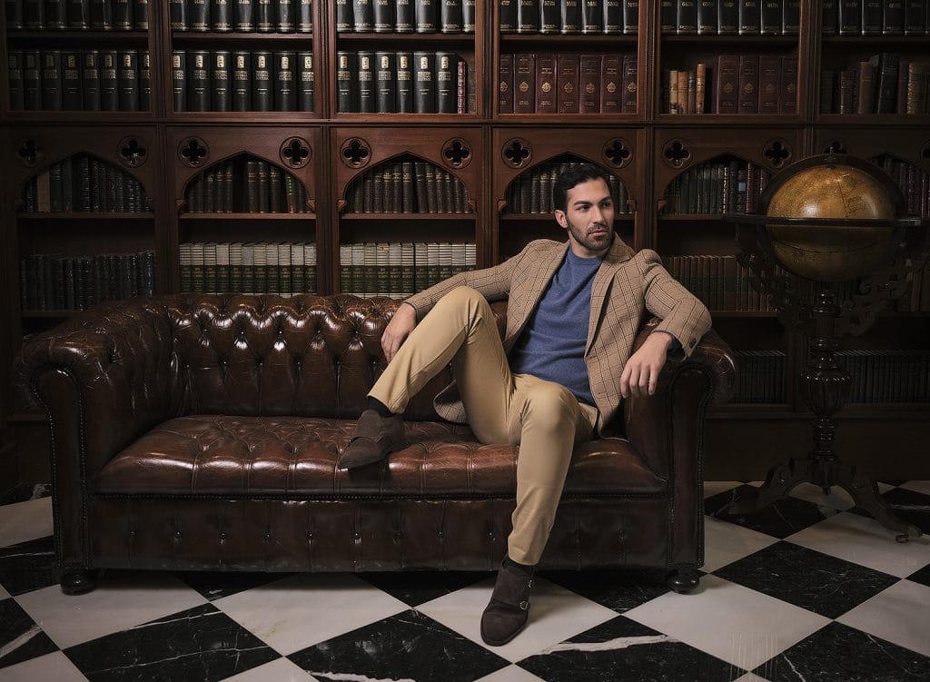 Model sitting on a sofa with our brown Portofino model